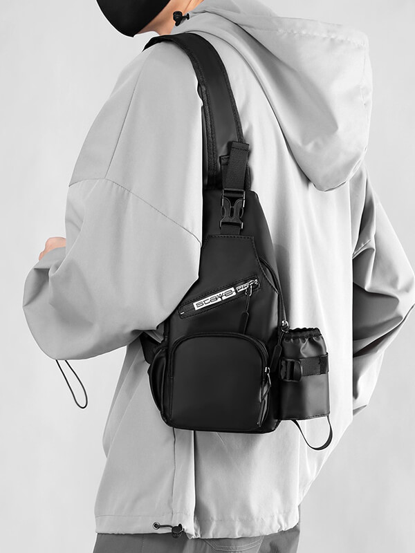 Man wearing a black sports crossbody bag with USB port and zipper closure, featuring comfort strap and softback design.